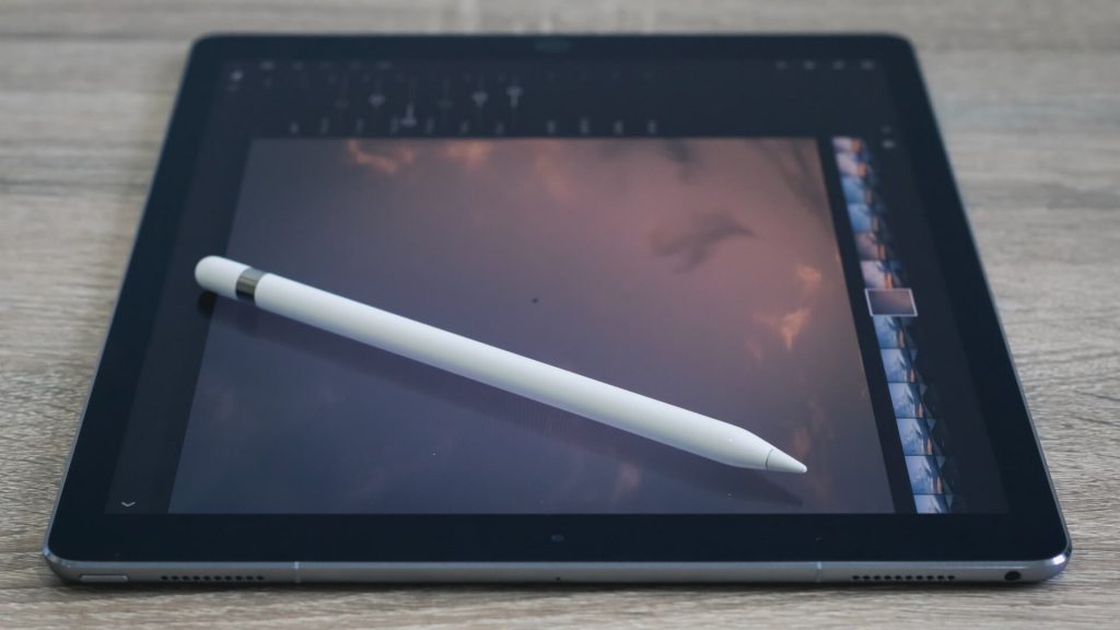 A tablet with a stylus pen on top